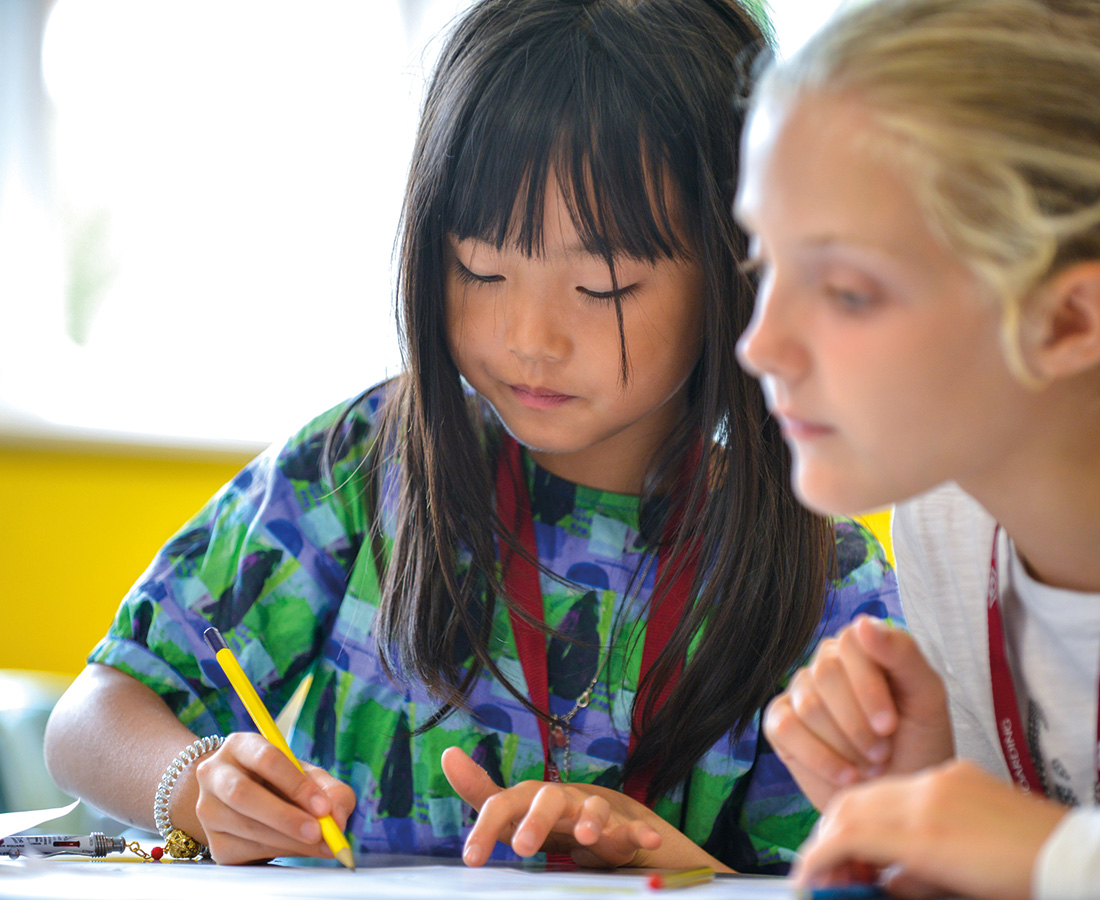 Female student drawing in class at camp dragon