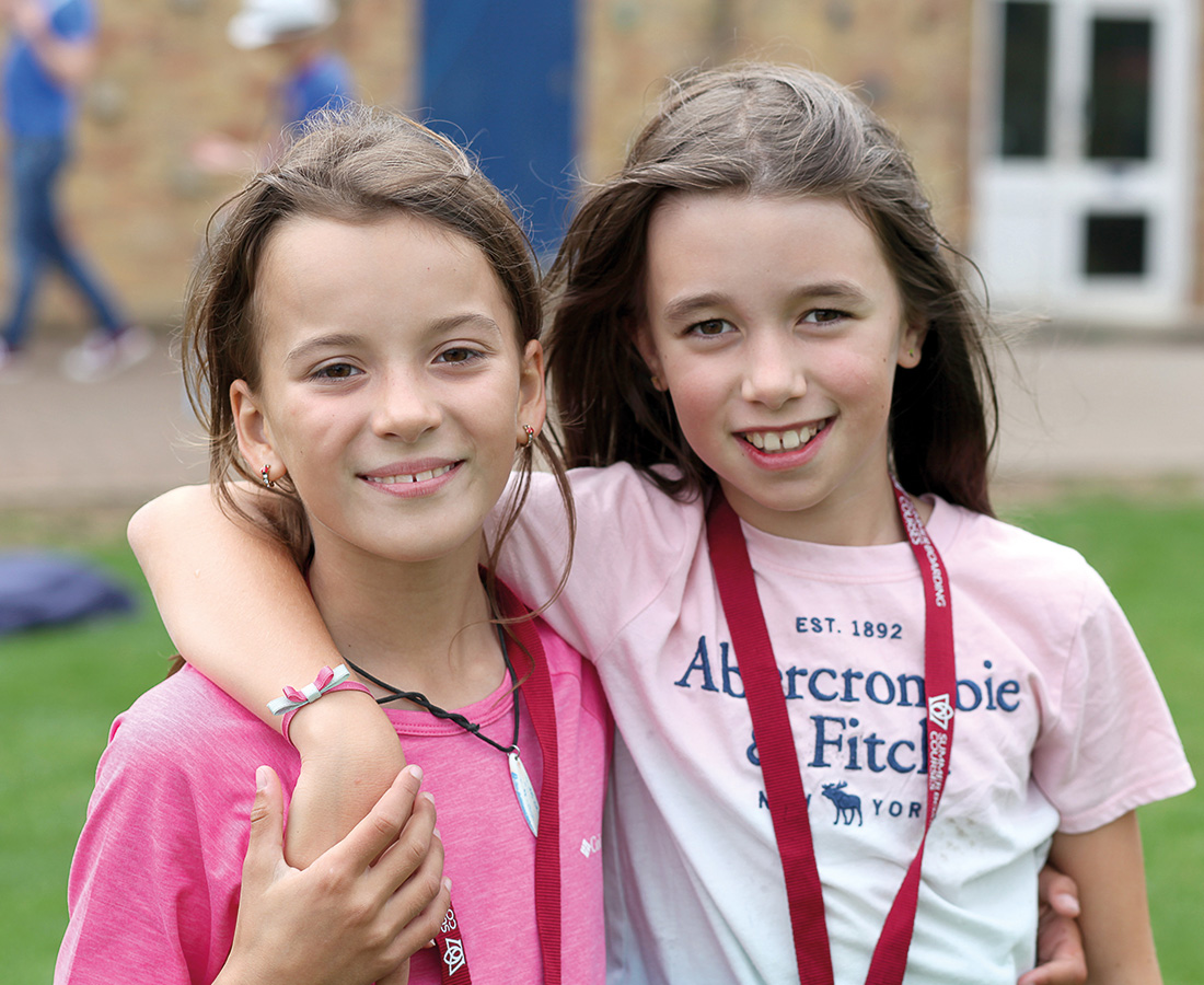 Two female students smiling at camp dragon