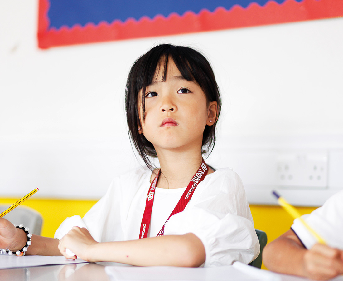 Young Female student at a desk concentrating in class